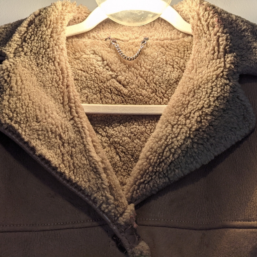 Vintage sheepskin coat with leather trim.